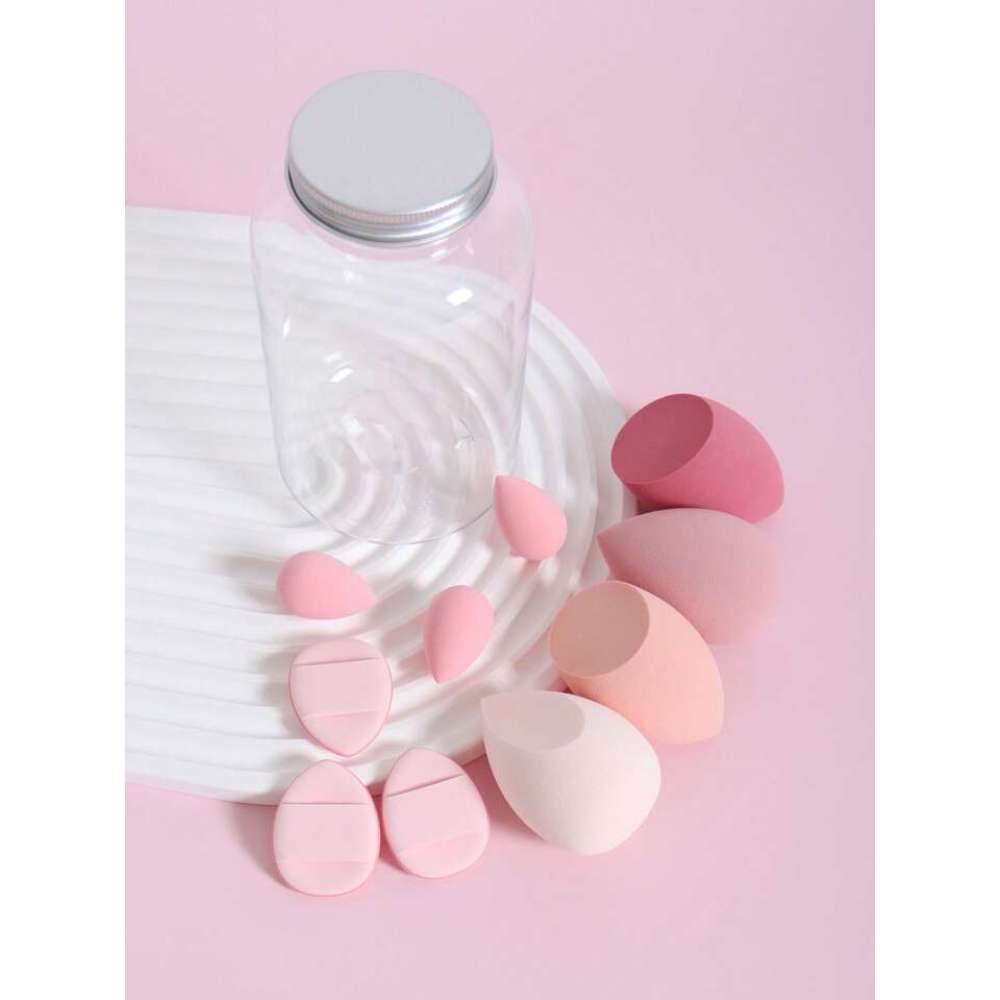 Pink makeup sponges and a clear container on a pink background