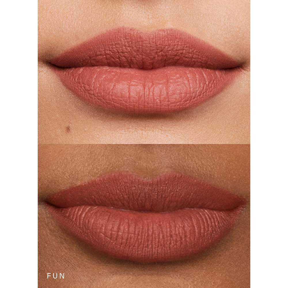Close-up of lips with a matte lipstick shade on a neutral background