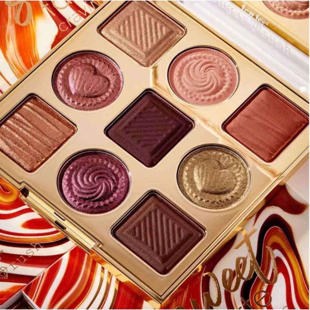 Makeup palette with various shades of eyeshadows on a colorful background