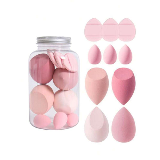 Set of pink makeup sponges in a clear container on a white background