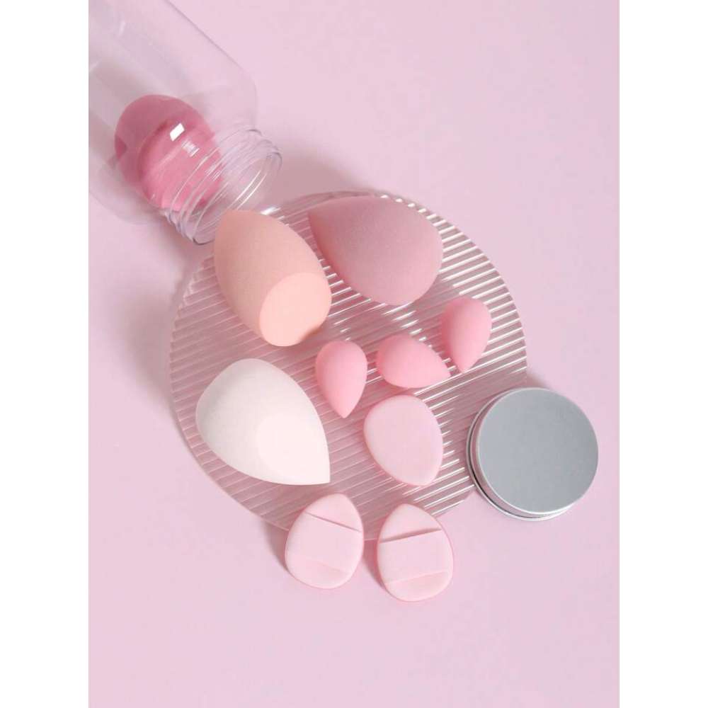 Set of pink and white makeup sponges on a pink background