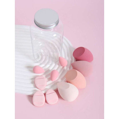 Pink makeup sponges and a clear container on a pink background