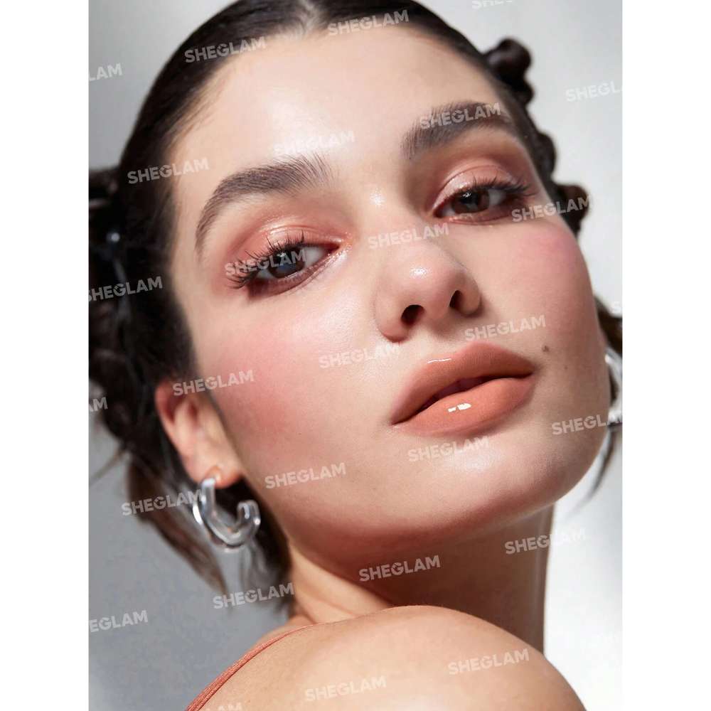 Close-up of a person with 'SHEGLAM' branding on a gray background