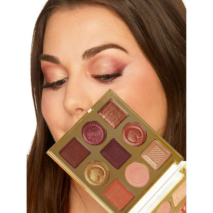 Makeup palette held by a person with a neutral background