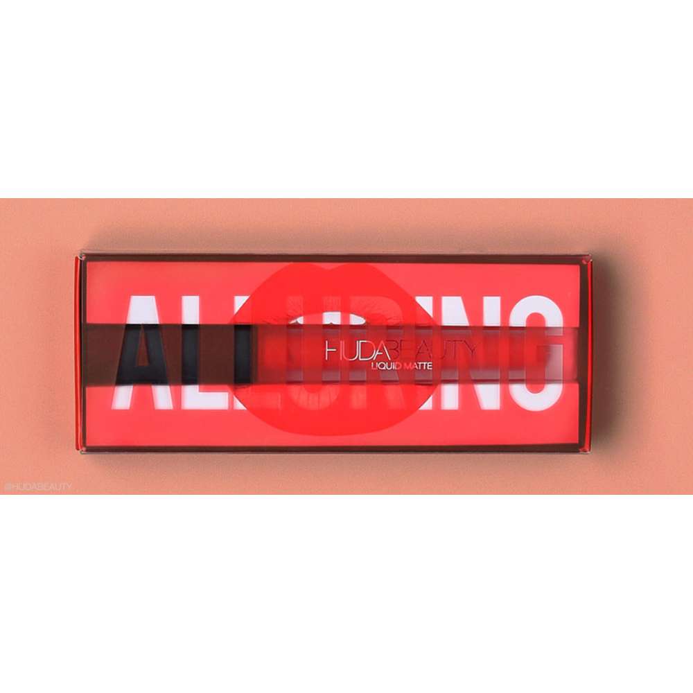Huda Beauty lip product set with red packaging on a peach background