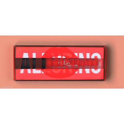 Huda Beauty lip product set with red packaging on a peach background