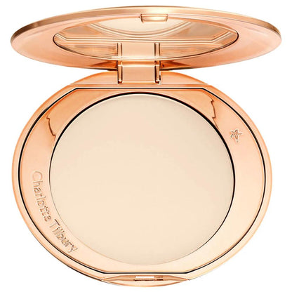 Rose gold compact powder with Charlotte Tilbury branding on a white background
