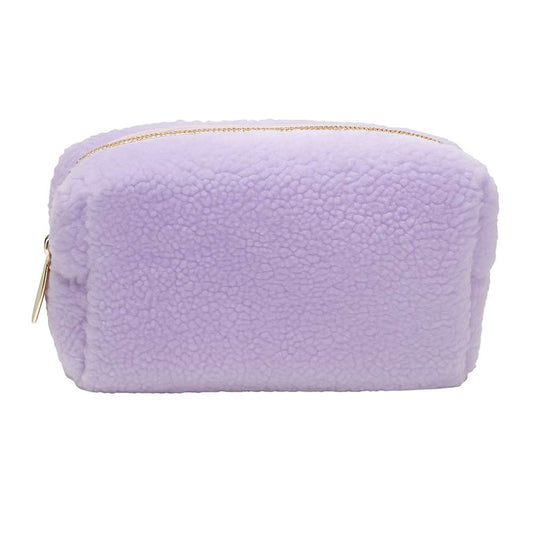 Purple fuzzy pouch with a gold zipper on a white background