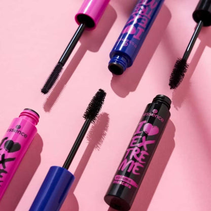 Multiple bottles of essence mascara on a pink background