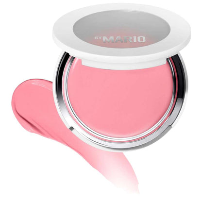 Pink makeup product with 'By Mario' branding on a white background