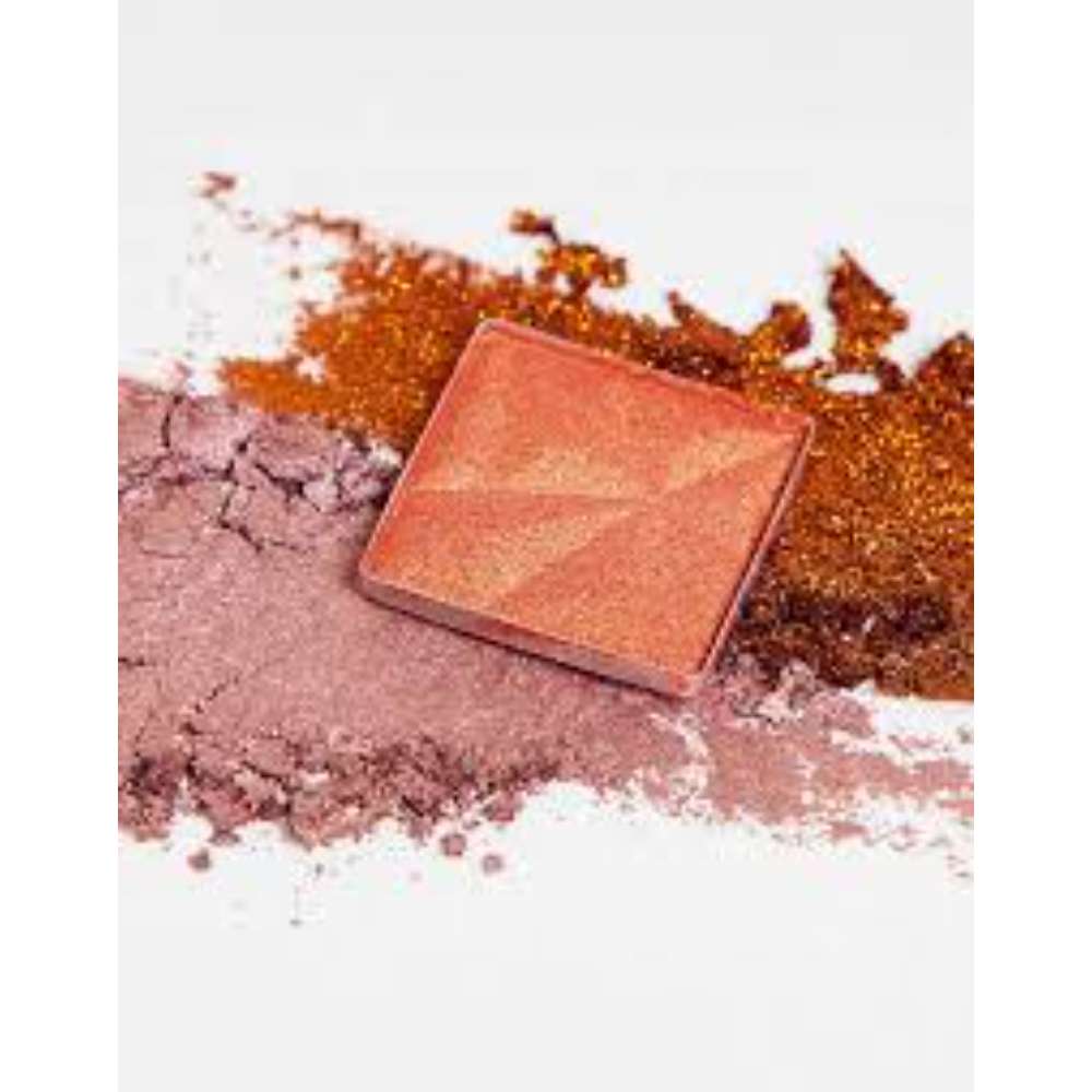 Makeup compact with scattered powder on a white background