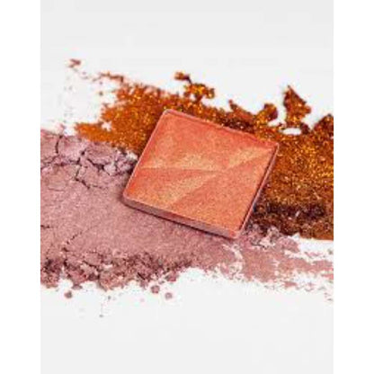Makeup compact with scattered powder on a white background