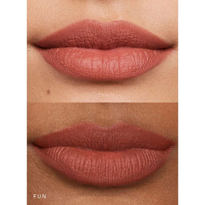 Close-up of lips with a matte lipstick shade on a neutral background