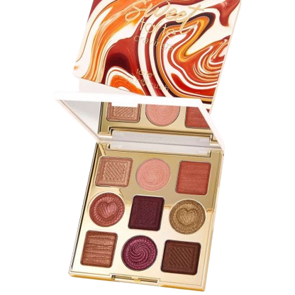 Makeup palette with swirled design on top, featuring various shades of brown and pink.