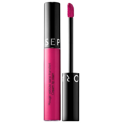 Pink lip stain with black applicator on a white background